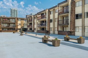 A sunny day at a courtyard surrounded by residential buildings.